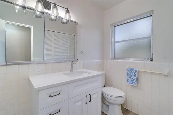a bathroom with a sink toilet and mirror