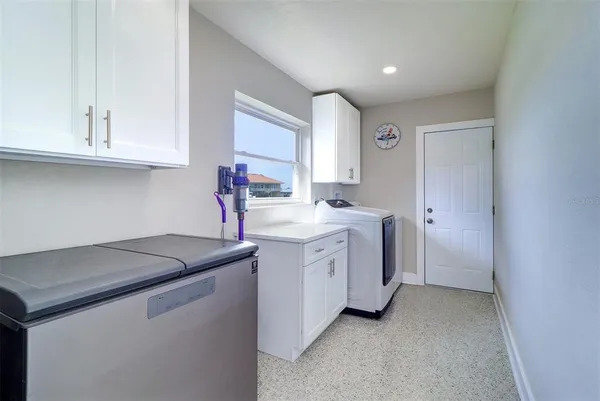 a utility room with sink dryer and washer