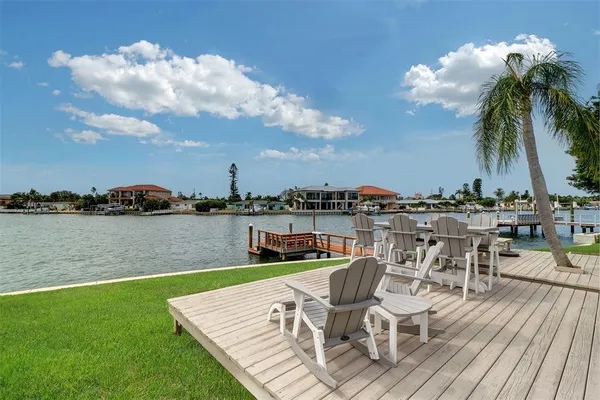 a view of a lake with couches chairs