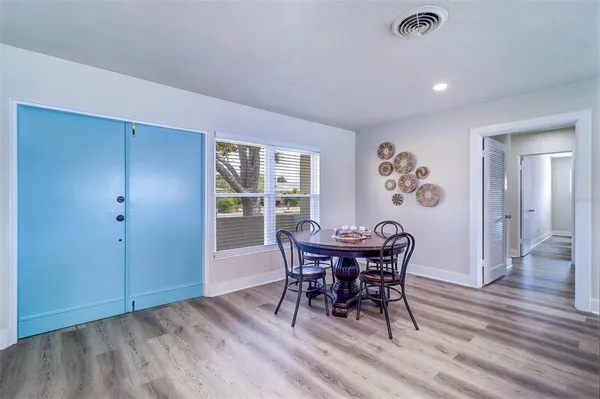 a view of a dining room with furniture and wooden floor