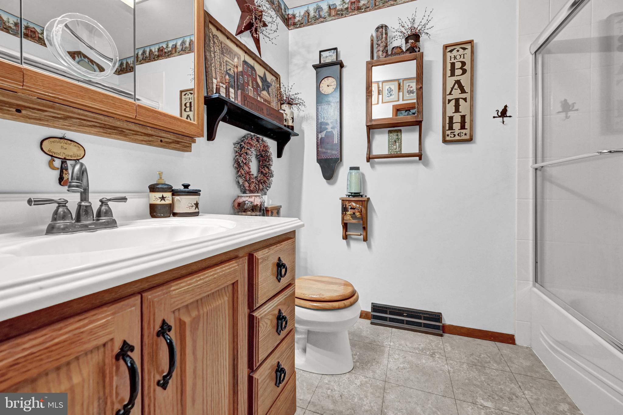 2697 Stoverstown Road Spring Grove, PA 17362 - Photo 16 of 38 a bathroom with a sink a toilet and a mirror