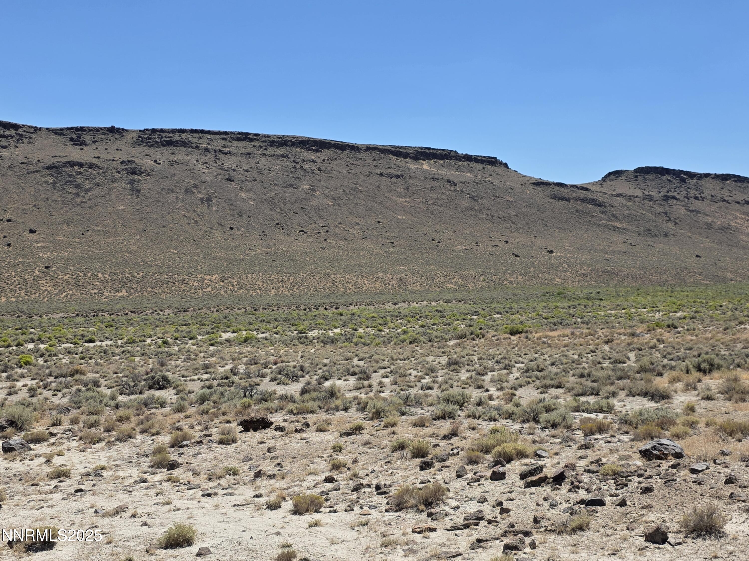 3304 High Rock Road, Unit HIGH ROCK ROAD APPROX 4 2 MILES Reno, NV 89510 - Photo 21 of 49 a view of a dry field with mountains in the background