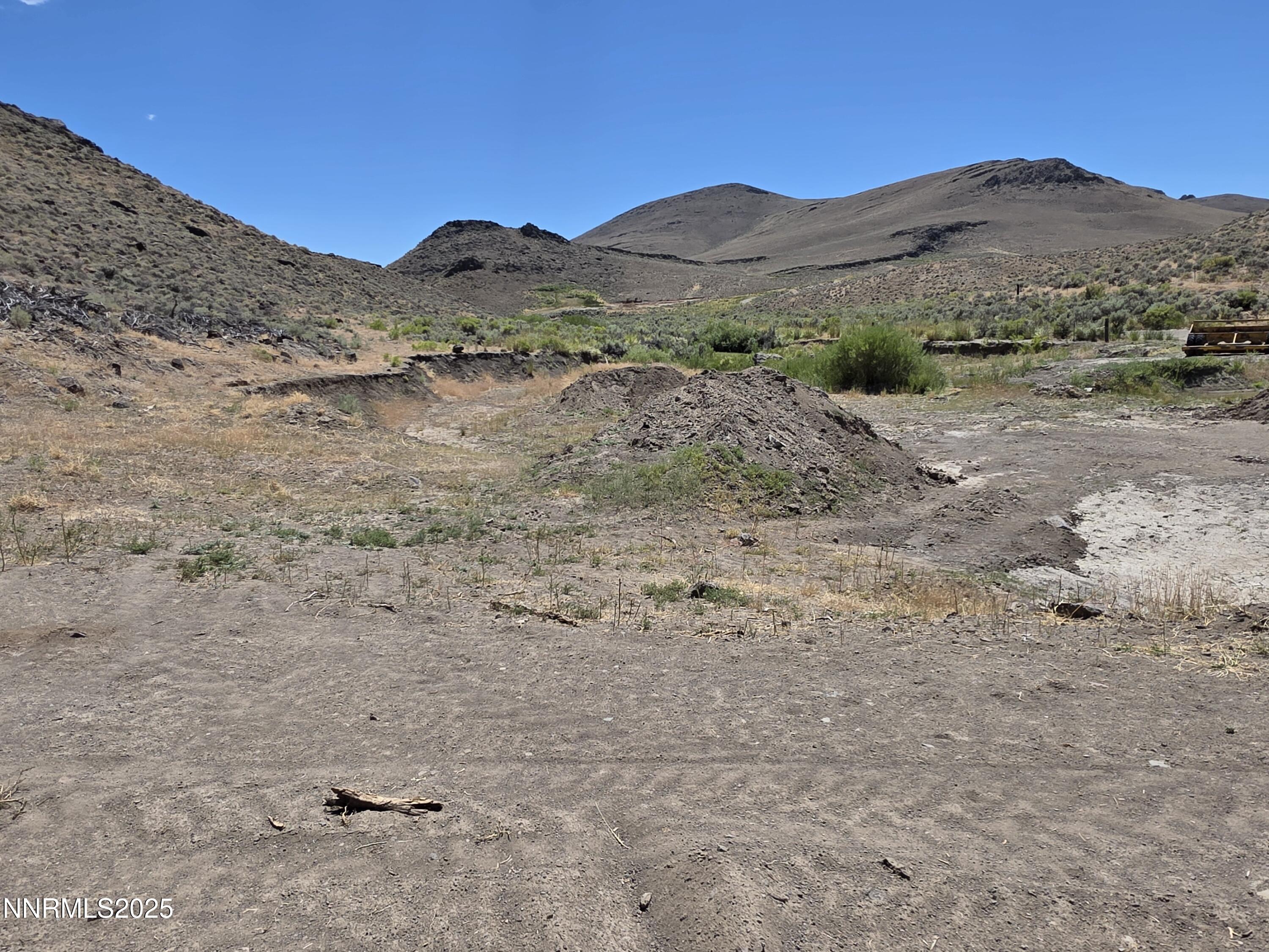 3304 High Rock Road, Unit HIGH ROCK ROAD APPROX 4 2 MILES Reno, NV 89510 - Photo 32 of 49 a view of a dry field with mountains in the background