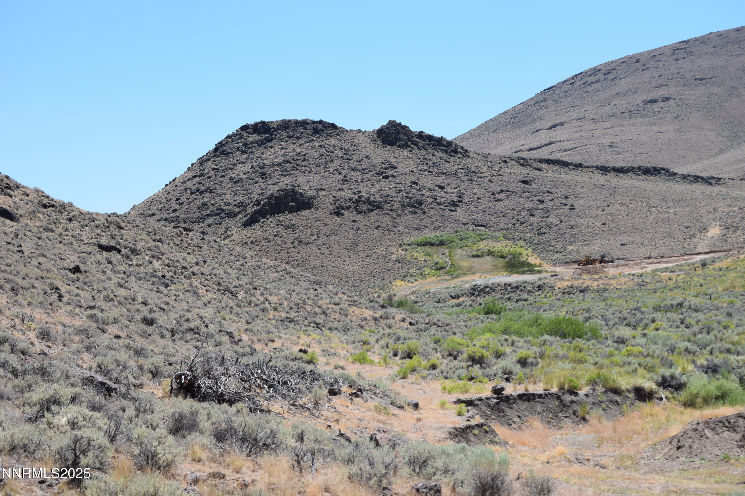 3304 High Rock Road, Unit HIGH ROCK ROAD APPROX 4 2 MILES Reno, NV 89510 - Photo 46 of 49 a view of a dry field with trees in the background