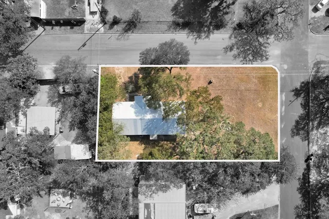 an aerial view of a house with a yard