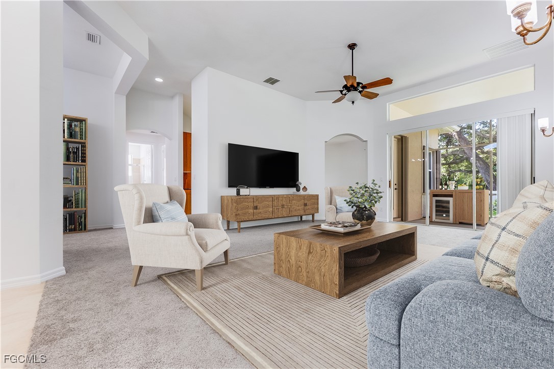 20340 Foxworth Circle Estero, FL 33928 - Photo 7 of 39 a living room with furniture a flat screen tv and a chandelier