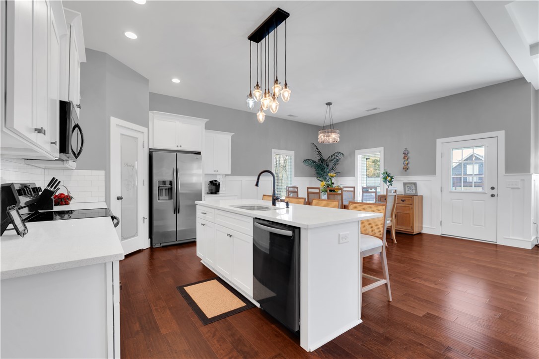 181 Amberwood Drive Anderson, SC 29621 - Photo 11 of 28 This modern kitchen features a spacious island and seamlessly connects to a bright dining area.