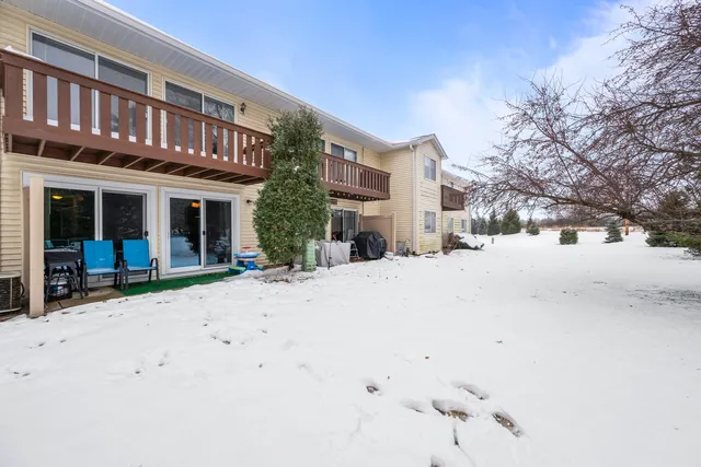 a view of a building with snow on the road