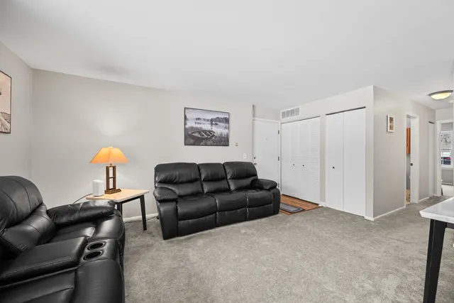 a living room with furniture and a lamp