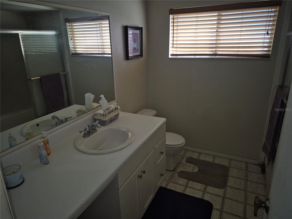 13710 Whitby Road Hudson, FL 34667 - Photo 16 of 21 a bathroom with a sink toilet and window