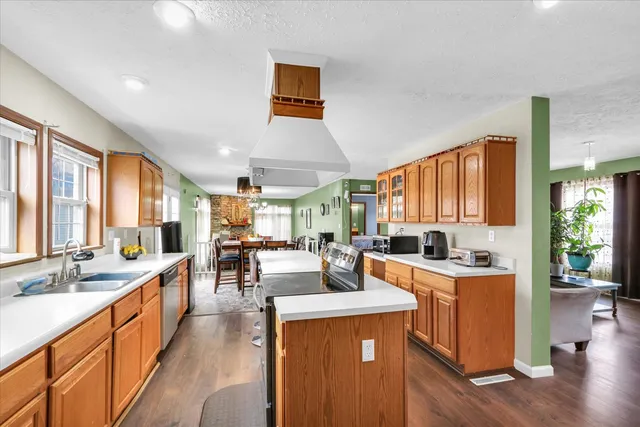 a living room with furniture a rug and a chandelier