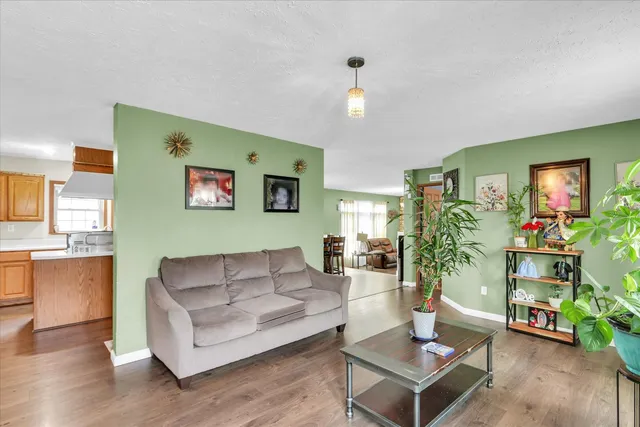 a living room with furniture fireplace and a large window