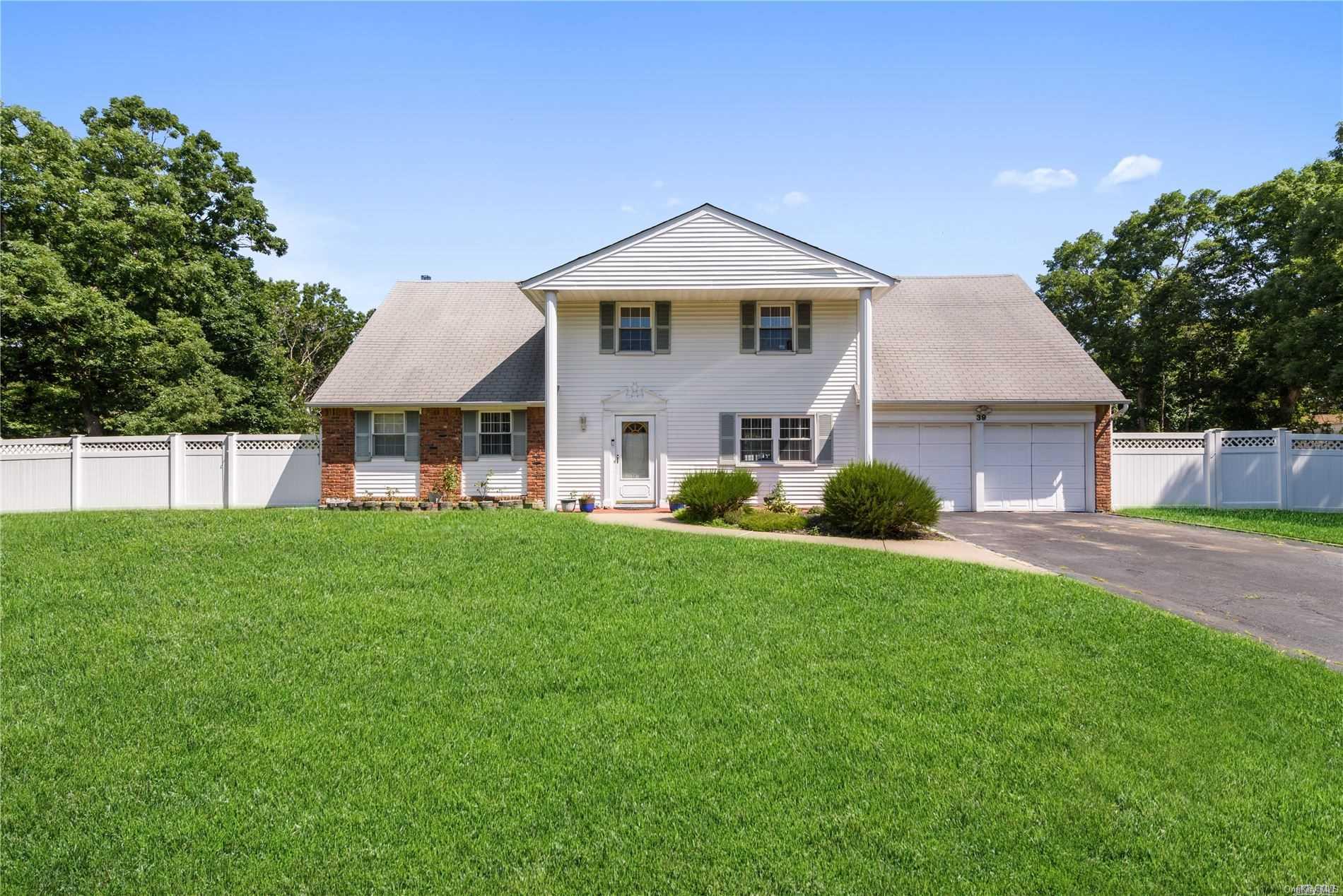 39 Cedar Avenue Coram, NY 11727 - Photo 1 of 1 a front view of a house with a yard and trees