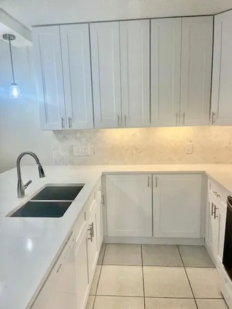a bathroom with a sink and a chandelier