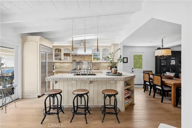 a kitchen with a table chairs stove and cabinets