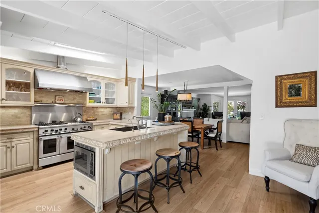 a kitchen with a stove a table and chairs in it