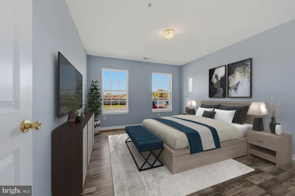 a bedroom with bed and a flat screen tv
