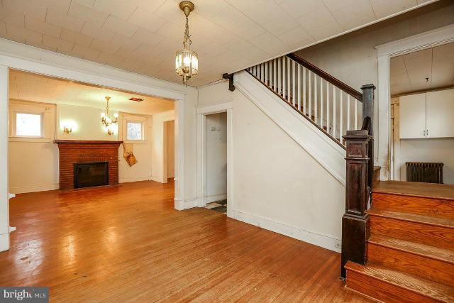 8402 Liberty Road Baltimore, MD 21244 - Photo 15 of 26 a view of an empty room with wooden floor fireplace and a window