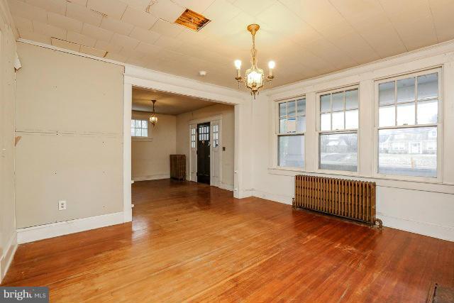 8402 Liberty Road Baltimore, MD 21244 - Photo 18 of 26 a view of an empty room with a window and wooden floor