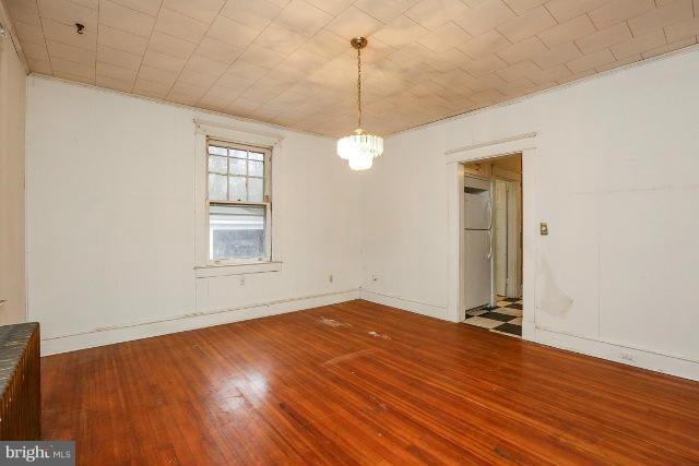 8402 Liberty Road Baltimore, MD 21244 - Photo 19 of 26 a view of a room with wooden floor and windows