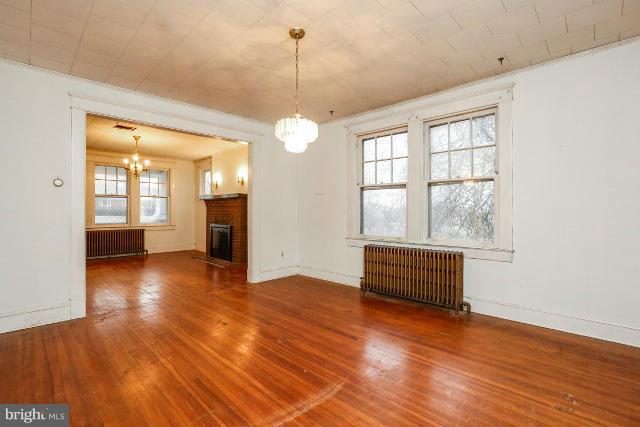 8402 Liberty Road Baltimore, MD 21244 - Photo 20 of 26 a view of an empty room with wooden floor and a window