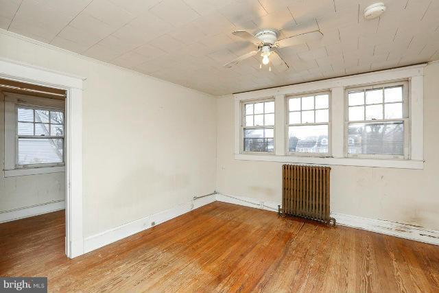 8402 Liberty Road Baltimore, MD 21244 - Photo 3 of 26 an empty room with wooden floor and windows
