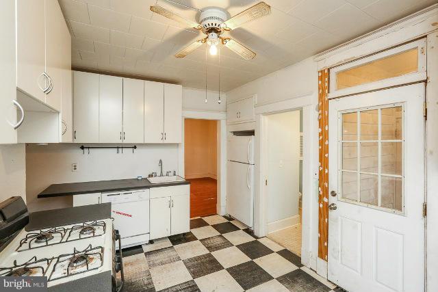 8402 Liberty Road Baltimore, MD 21244 - Photo 21 of 26 a kitchen with stainless steel appliances a stove a refrigerator and cabinets