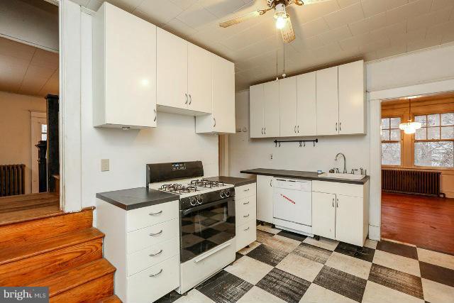 8402 Liberty Road Baltimore, MD 21244 - Photo 22 of 26 a kitchen with stainless steel appliances a stove a sink and white cabinets