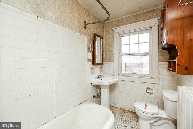 8402 Liberty Road Baltimore, MD 21244 - Photo 7 of 26 a bathroom with a sink a toilet and a mirror