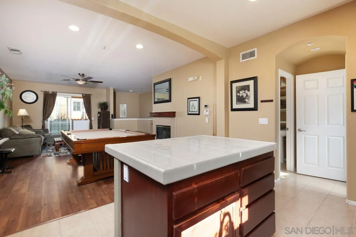 2248 Huntington Point Road, Unit 80 Chula Vista, CA 91914 - Photo 17 of 31 a room with a table chairs and wooden floor
