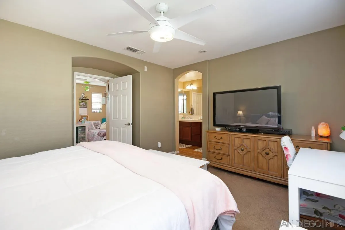 2248 Huntington Point Road, Unit 80 Chula Vista, CA 91914 - Photo 23 of 31 a bedroom with a bed and a flat screen tv