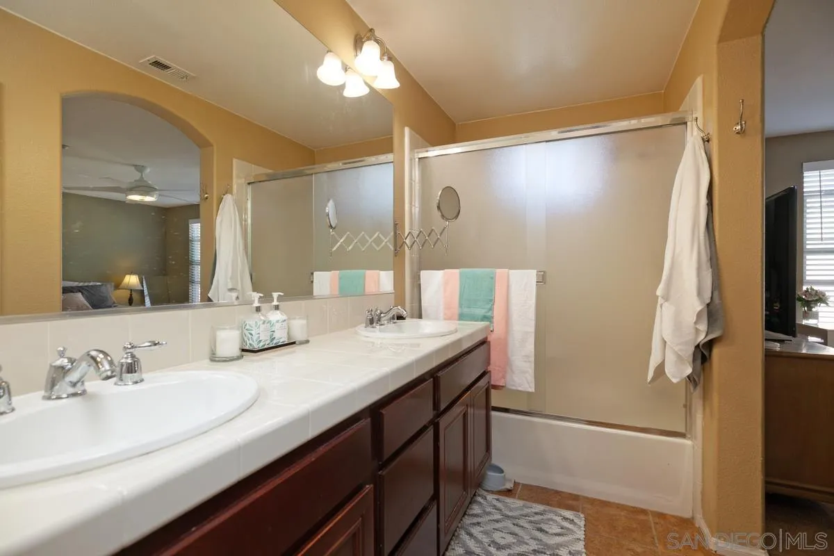 2248 Huntington Point Road, Unit 80 Chula Vista, CA 91914 - Photo 24 of 31 a bathroom with a sink a mirror and a shower