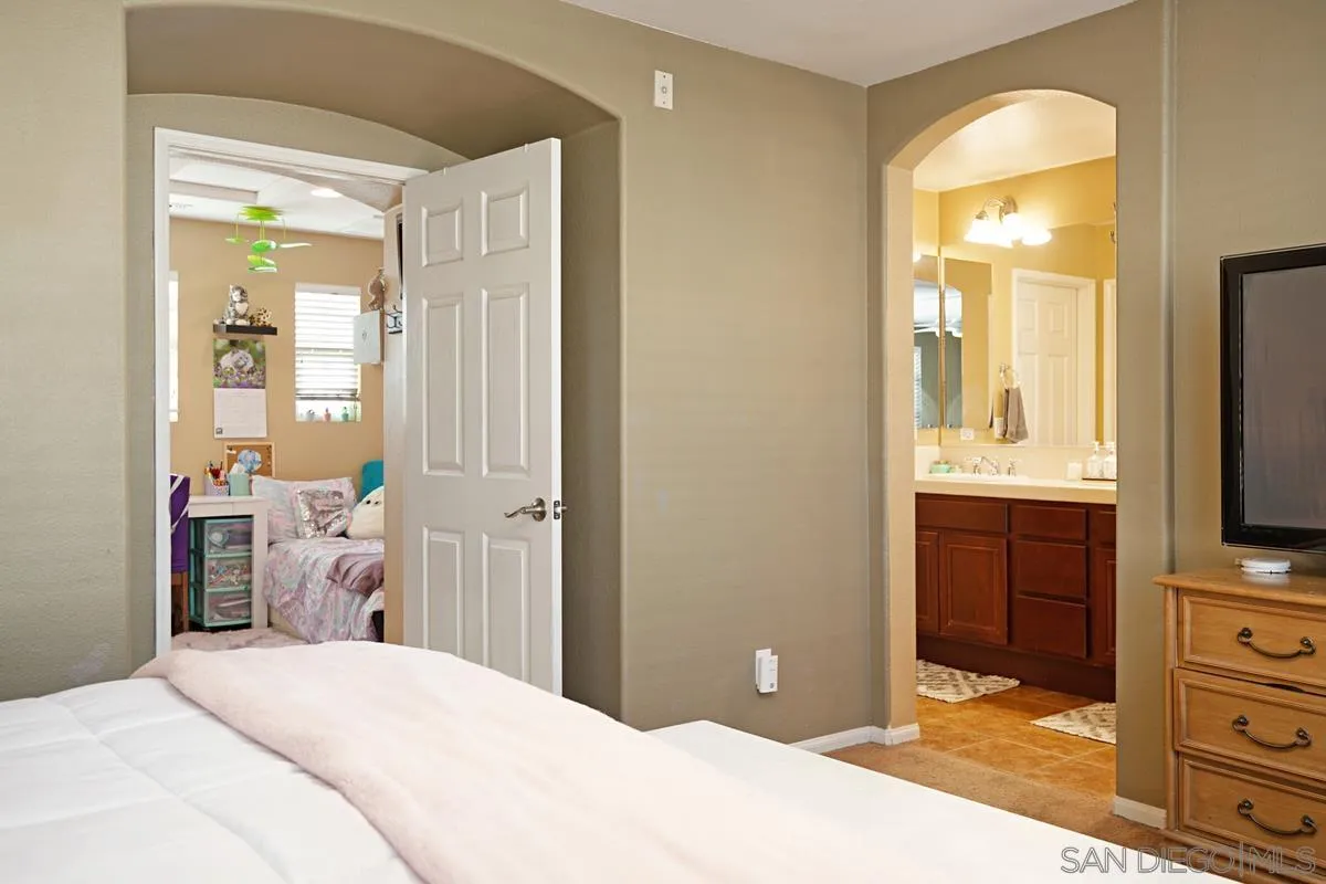 2248 Huntington Point Road, Unit 80 Chula Vista, CA 91914 - Photo 25 of 31 a bedroom with a bed and a flat tv screen in it