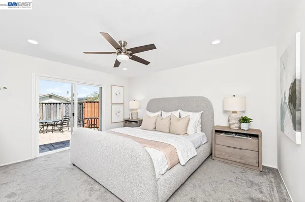 a bedroom with a large bed and a chandelier