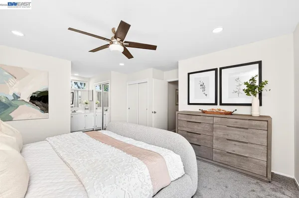 a bedroom with a large bed and a chandelier