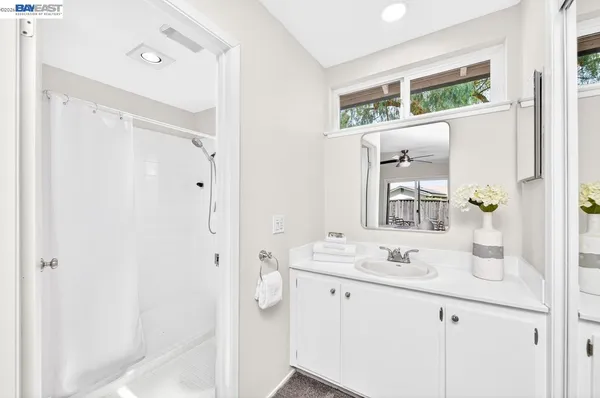 a bathroom with a sink vanity and mirror