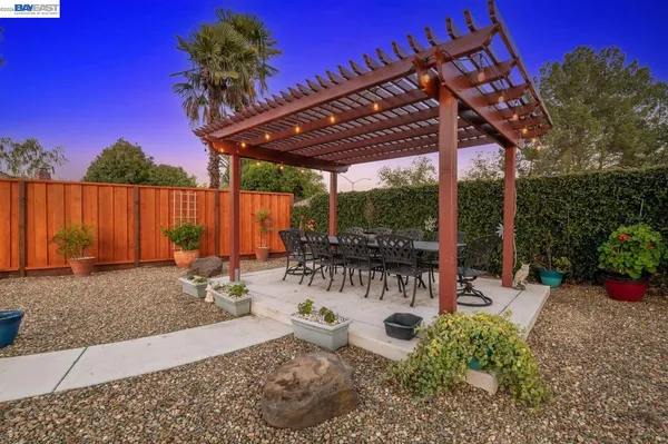 a view of a patio with table and chairs potted plants with wooden floor
