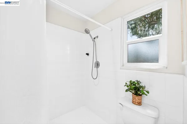a white painted room with a window