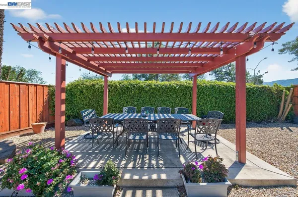 a view of a patio with a table chairs and a potted plant