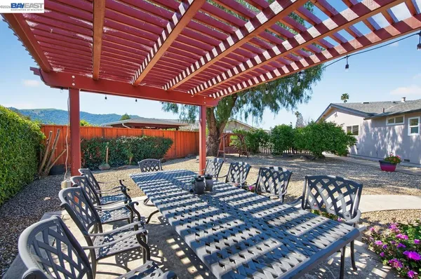a view of a patio with table and chairs and wooden floor