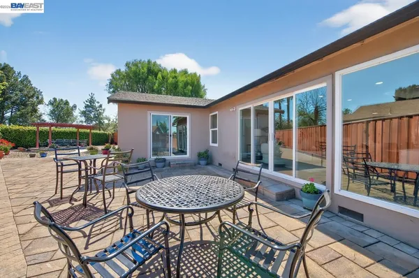 a view of backyard with outdoor seating a patio and plants