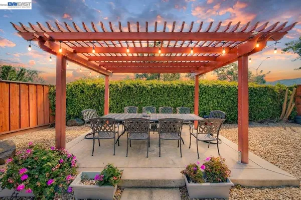 a view of a patio with a table and chairs