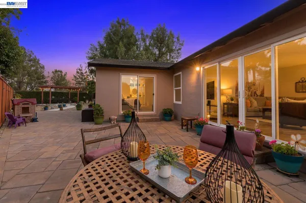 a view of a patio with couches table and chairs and potted plants