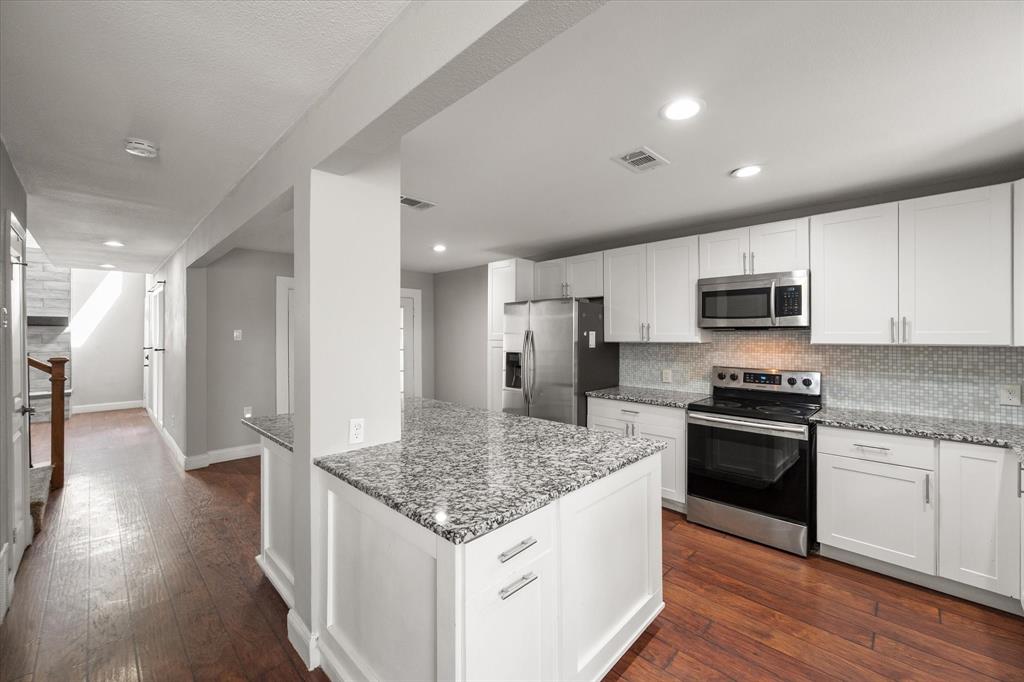 207 East Harwood Road, Unit 10 Euless, TX 76039 - Photo 12 of 34 a kitchen with stainless steel appliances granite countertop a sink stove and refrigerator