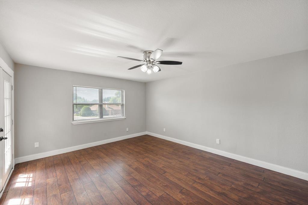 207 East Harwood Road, Unit 10 Euless, TX 76039 - Photo 14 of 34 wooden floor in an empty room with a window