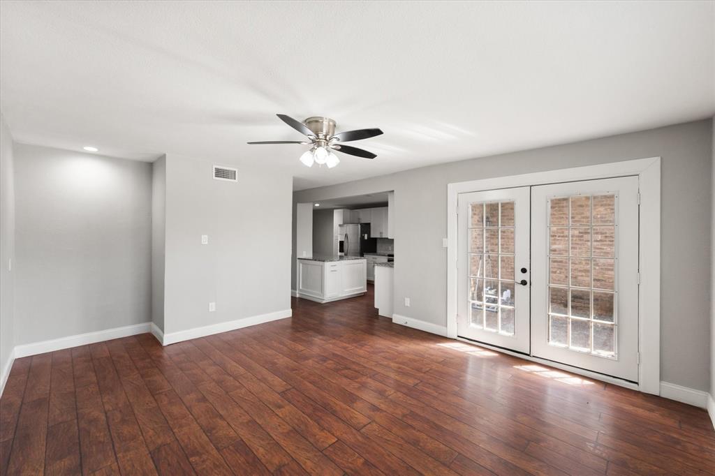 207 East Harwood Road, Unit 10 Euless, TX 76039 - Photo 16 of 34 a view of an empty room with wooden floor and a window