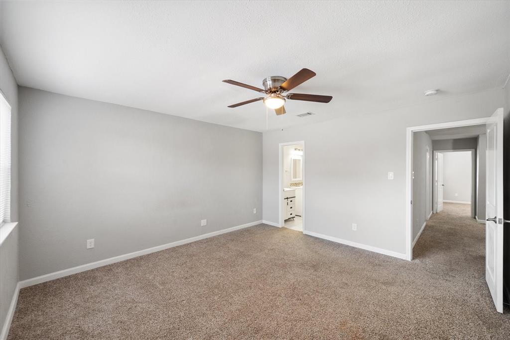 207 East Harwood Road, Unit 10 Euless, TX 76039 - Photo 22 of 34 an empty room with a ceiling fan and a window
