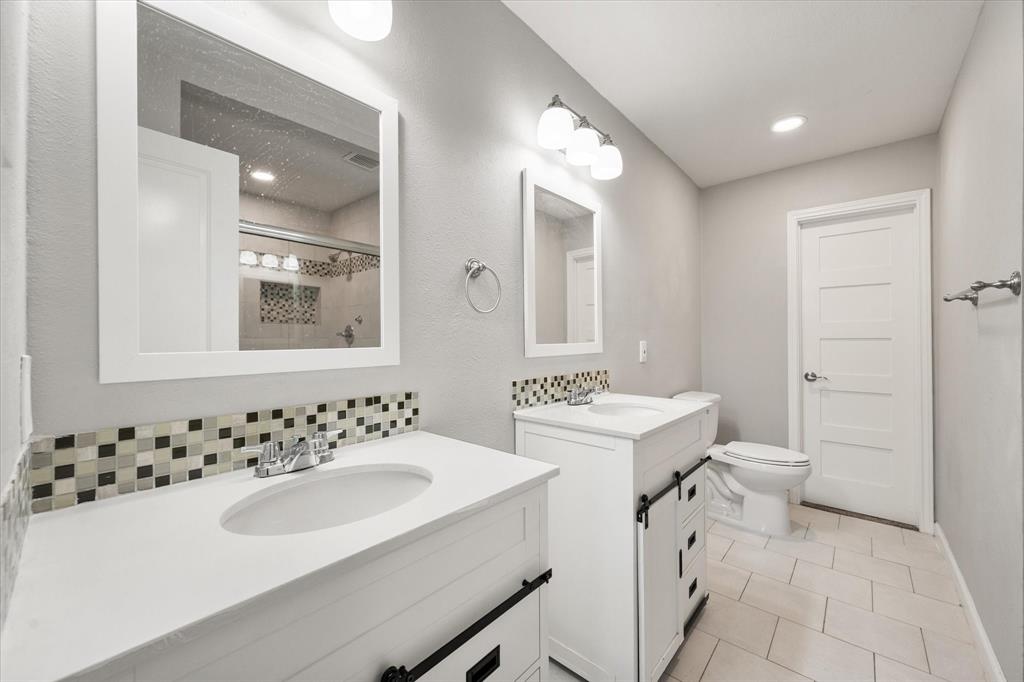 207 East Harwood Road, Unit 10 Euless, TX 76039 - Photo 23 of 34 a bathroom with a sink and a toilet