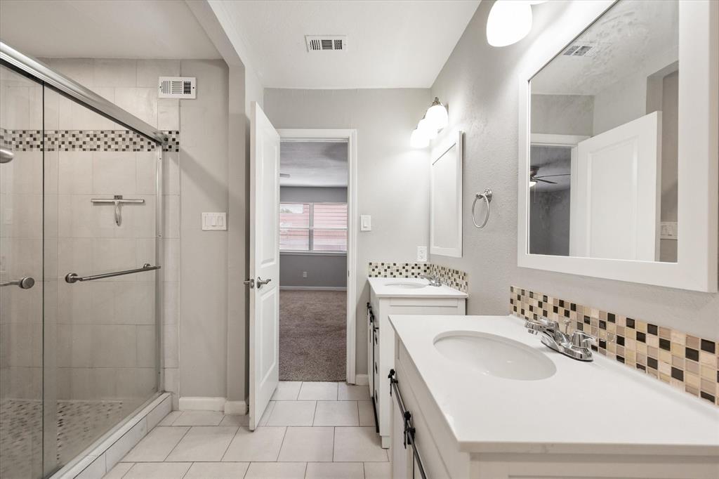 207 East Harwood Road, Unit 10 Euless, TX 76039 - Photo 25 of 34 a bathroom with a sink a toilet and shower