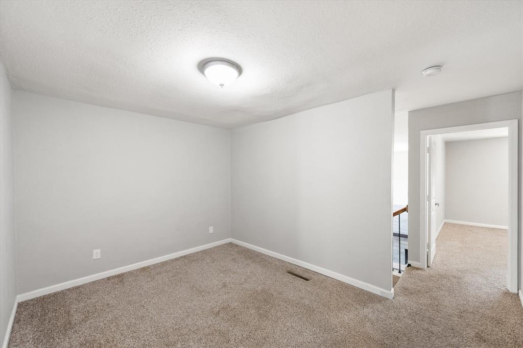 207 East Harwood Road, Unit 10 Euless, TX 76039 - Photo 27 of 34 an empty room with a empty space and windows